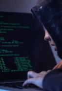 computer hacker in hooded shirt typing software algorithms and stealing data from computer network on laptop (1)